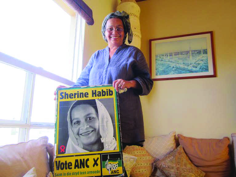 Habib holds her campaign poster