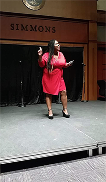 A student in red delivers her monologue