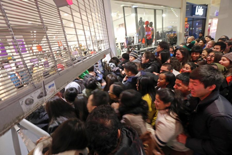 (Cambridge, MA,11/29/13)   a small horde of shoppers rush the gate as it opens at H&M  as Black Friday starts the holiday shopping season at the Galleria Mall in Cambridge.   Friday,  November  29, 2013.  (Staff photo by Stuart Cahill)