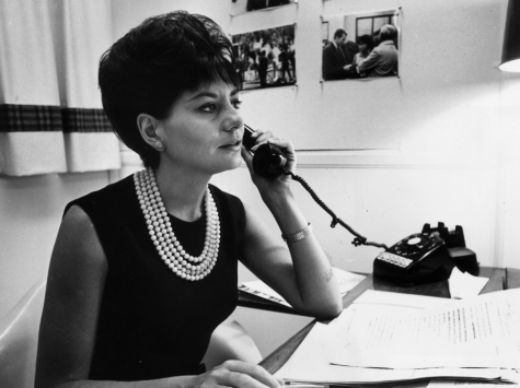 Barbara Walters takes a phone call at her desk in New York City, circa 1964. Courtesy of Hulton Archive. 